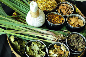 White Thai Herbal Compress with Lemongrass and Assorted Dried Herbs in Basket for Thai Spa,...
