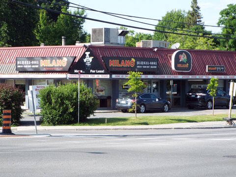 Ottawa, ON, Canada, June 14, 2025: A strip mall featuring a pizza restaurant called 'Milano Pizza" at 2241 St. Laurent Blvd.