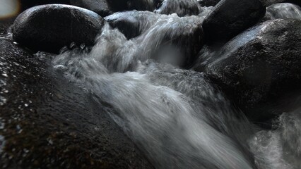 Scenic river with flowing water, rocks, trees, underwater view and sun reflection