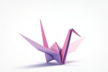 A beautifully folded pink and purple origami crane on a clean white background, showcasing the delicate art of paper crafting.