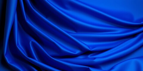 Fototapeta premium Deep blue fabric draped elegantly, soft folds and shadows, material, scene