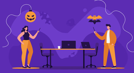 Business colleagues in a festive Halloween-themed office. A man and a woman point at seasonal decorations, ideal for holiday work events or marketing.