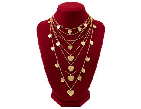 Collection of delicate gold heart necklaces layered on a velvet bust isolated on transparent background