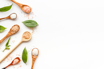 Obraz na płótnie Canvas Beauty spa therapy cosmetics and wellness flat lay - sea salt in many spoons with flowers, top view