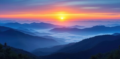 Obraz premium Majestic sunrise over misty mountains and valleys