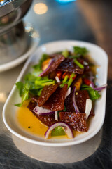 Close up of sliced sheets of dried and crispy pork spicy salad