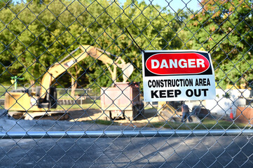 Construction Area Danger Sign with backhoe work zone in background