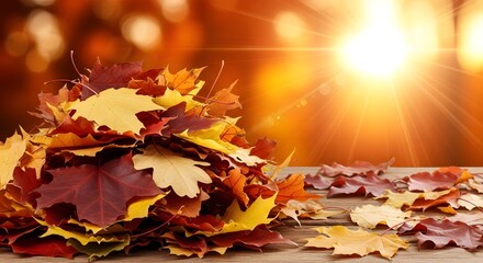 Pile of colorful autumn maple leaves on a wooden table with bright sunlight and lens flare, evoking a warm and cozy fall atmosphere