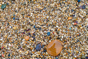 background of colorful beach sand and stones, top view