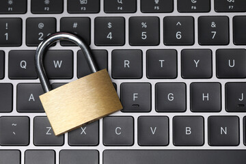 Cyber safety. Metal padlock on keyboard, top view