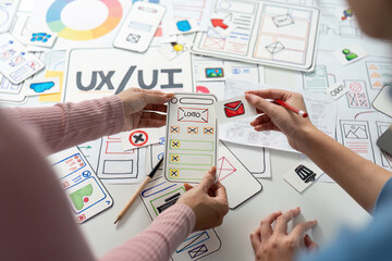 UX and UI Design Exploration. Team discussing mobile app layout and design elements.