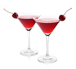 Martini cocktail with cherries in glasses on white background