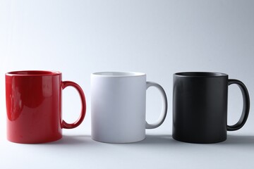 Mugs on light background. Mockup for design