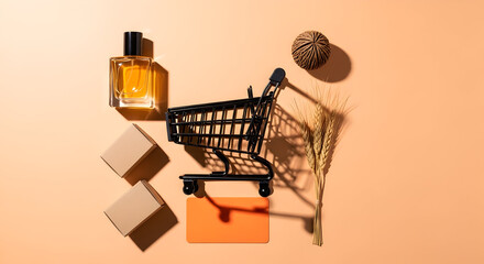 Arrangement of shopping cart, perfume, boxes, and dried wheat on an orange background, symbolizing retail and commerce