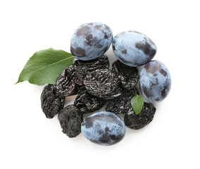 Dried prunes, fresh plums and green leaves isolated on white, top view