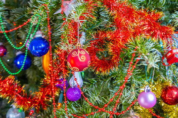 beautifully decorated Christmas tree with red and gold ornaments, twinkling lights, and reflective...