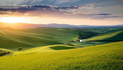 Obraz premium serene landscape rolling green fields sunset rural countryside