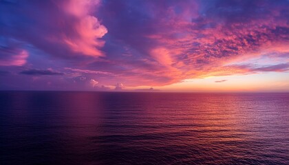 Fototapeta premium a breathtaking sunset sky filled with vibrant pink and purple clouds creating a serene atmosphere