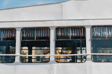 Ferry Windows with Nautical Striped Awnings and Reflections