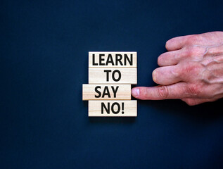 Learn to say no symbol. Concept words phrase Learn to say no on beautiful wooden blocks. Beautiful black paper background. Businessman's hand. Business psychological Learn to say no concept Copy space