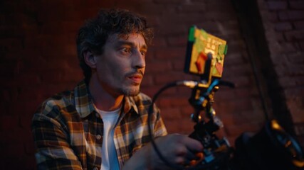 Professional videographer filming club performance in dark atmosphere closeup.