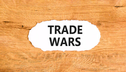 Trade wars symbol. Concept word Trade wars on beautiful white paper. Beautiful wooden paper...