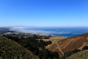 View of the bay from a hilltop against a bright blue sky.  California. 2024