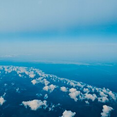 Fototapeta premium Photo of an aerial view of fluffy white clouds against a blue sky creates a peaceful scene