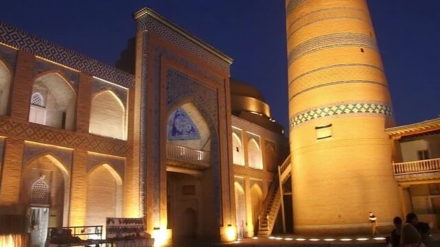 Khiva, Uzbekistan - July 30, 2025; a panoramic view of the Islam Khodja Madrasa with its very high minaret at night , UNESCO World Heritage Site
