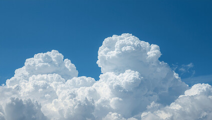 Fluffy White Cumulus Clouds Against Clear Blue Sky
