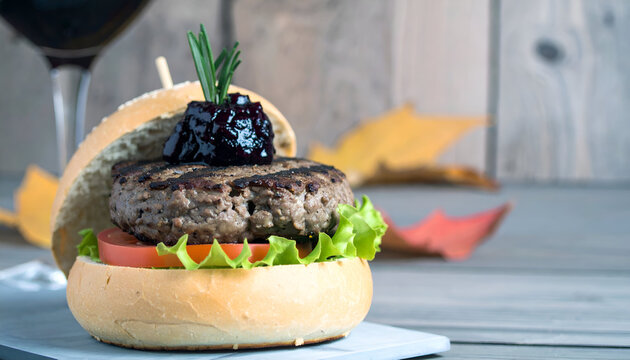 Closeup of Juicy Beef Burger with Berry Sauce and Rosemary