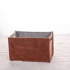 Functional storage box designed with a combination of felt and leather, ideal for organizing items in living rooms or offices, adding a modern touch to any space.