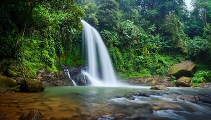 Obraz premium majestic waterfall cascading over rocks and lush greenery in tranquil nature
