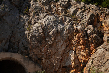 Rocky Cliff Face with Tunnel Entrance