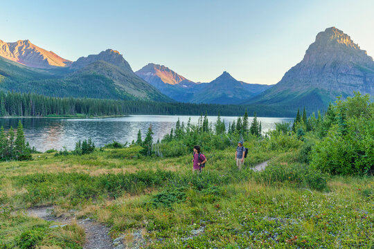 hikers at sunset in Two Medicine area of Glacier National Park