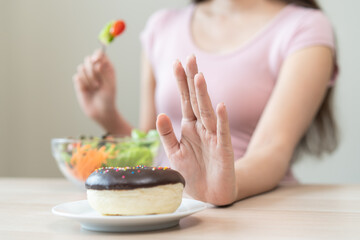Women avoid to eat dessert while controlling their diet session.