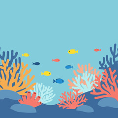 Colorful coral reef with small fish swimming in blue water