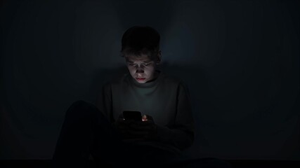Teenager looking at phone screen with unknown caller in dark room  