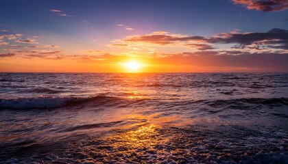 golden hour paints the sky with vibrant hues as the sun dips below the horizon casting a mesmerizing reflection on the tranquil ocean waves