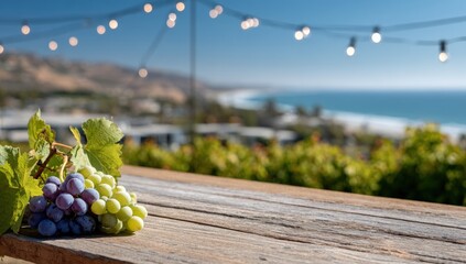 Grapes on a wooden table overlooking the ocean