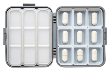 Open the gray pill organizer box with white medicine capsules isolated with transparent background