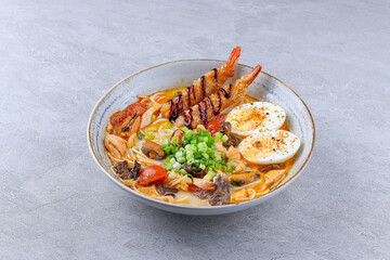Japanese ramen soup with shrimp tempura, boiled egg, and vegetables