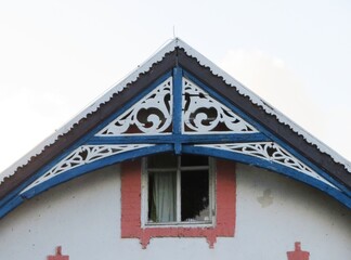 traditional old historic wooden architecture house with carvings in Nida, Curonian spit with a fountain in Lithuania, Europe