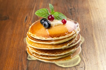 A stack of fluffy tasty sweet pancakes with syrup
