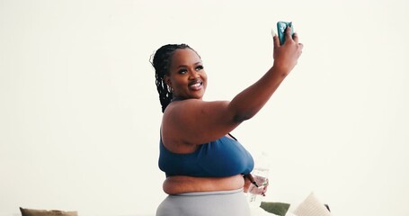Fit black woman in sports outfit capturing selfie with phone - Powered by Adobe