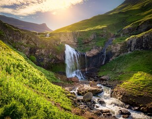 sunlit waterfall cascading down rocky slopes into lush green valley