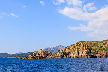 Naklejka premium Rocky coastline near Cargèse with Mediterranean landscape, France, Corsica, Cargèse, 19 June 2025