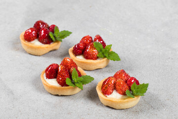 Mini Vegan Round Strawberry tartlets. Light gray background. Close up