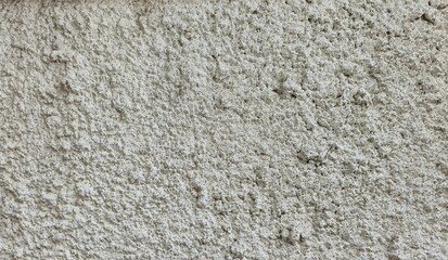 Rough white cement wall texture, rough, uneven surface, house wall, white painted house wall, and rough cement surface close up.