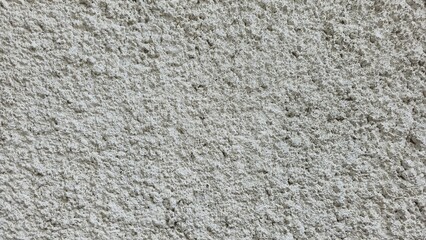 Rough white cement wall texture, rough, uneven surface, house wall, white painted house wall, and rough cement surface close up.